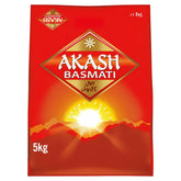 A 5kg red bag of Akash - Basmati Rice with sunrise and mountain imagery, gold English and multilingual text, delivers premium long-grain basmati rice for an authentic taste.